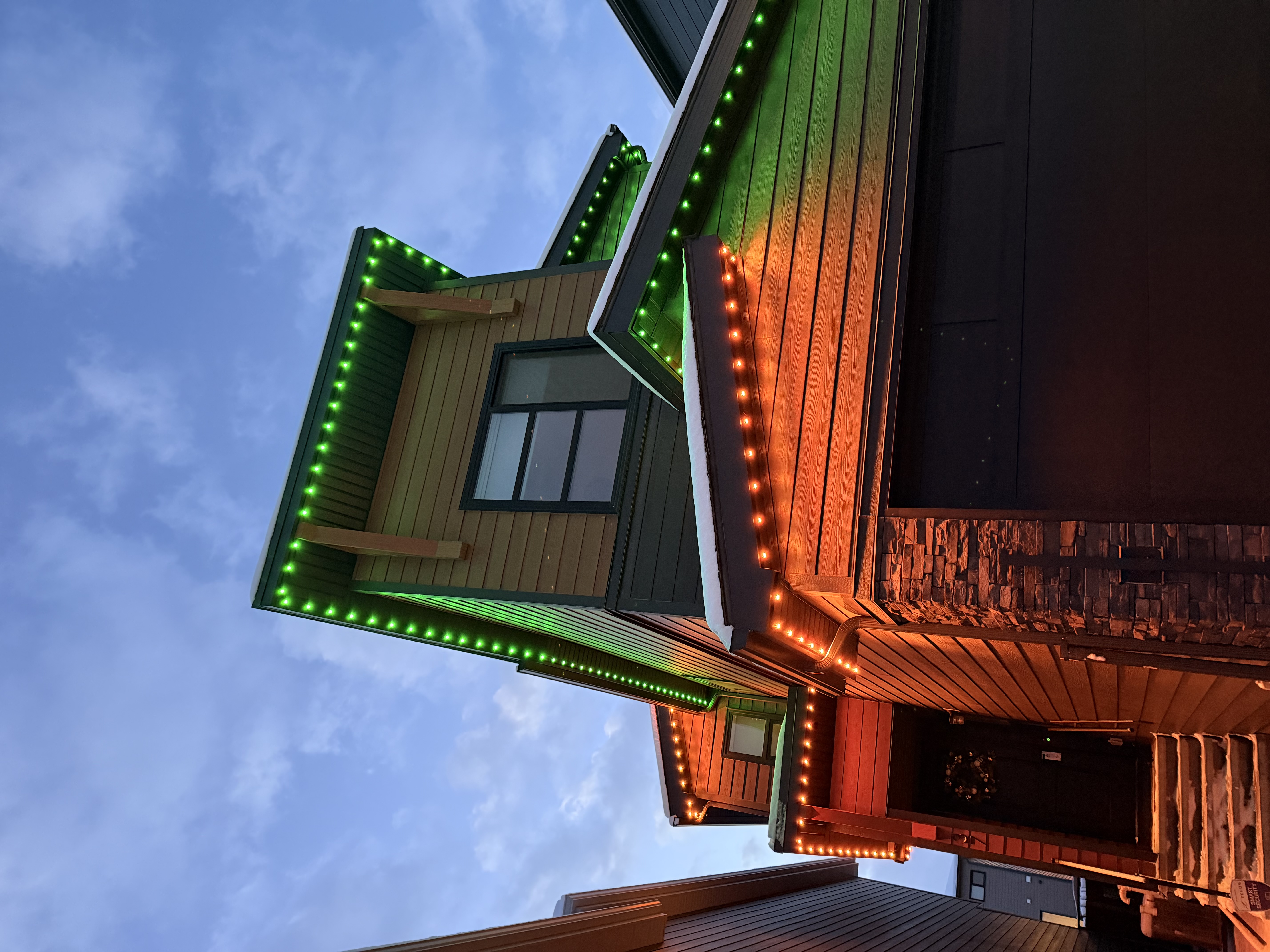 Colorful event lighting display on a Calgary residential roofline